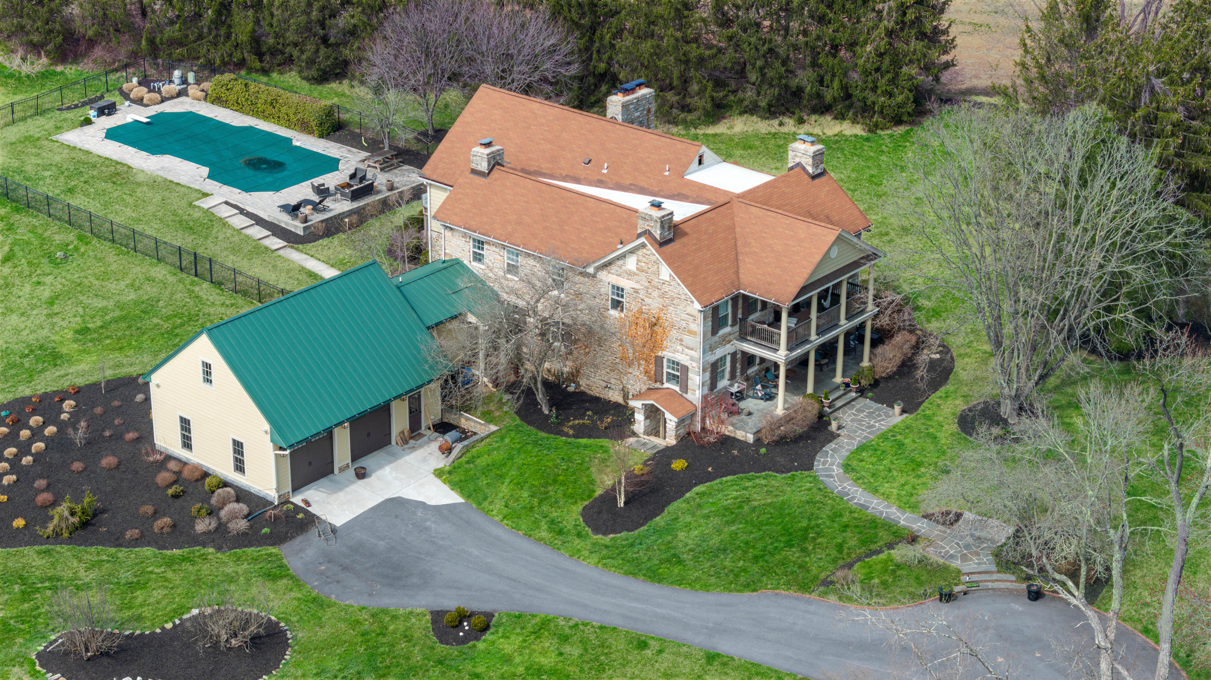 15314 PRICEVILLE ROAD, SPARKS GLENCOE, MD 21152 – Aerial view of historic stone manor estate with saltwater pool, green-roofed outbuildings, and mature trees in Sparks, Maryland