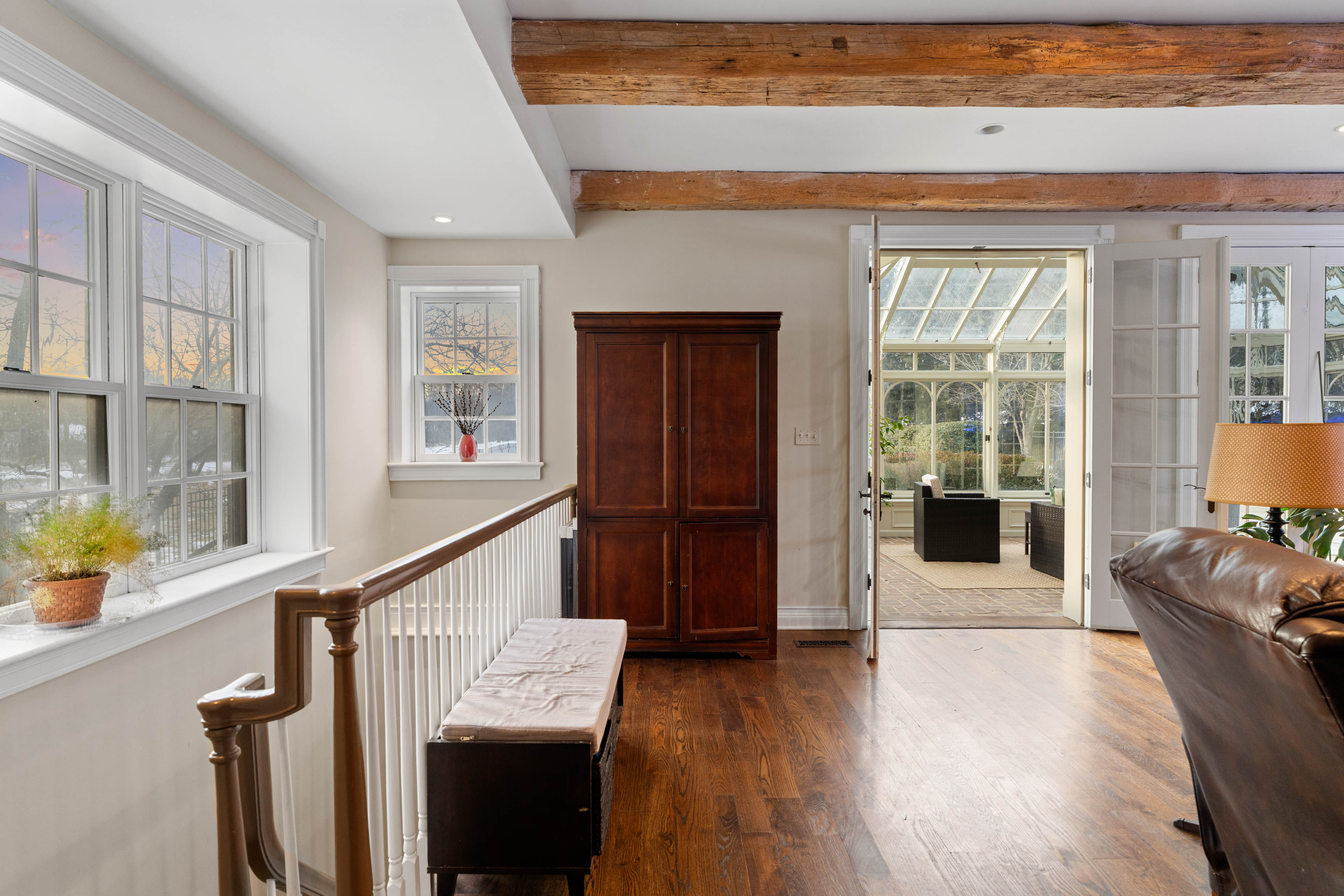 15314 PRICEVILLE ROAD, SPARKS GLENCOE, MD 21152 – Bright open interior with hardwood floors, exposed ceiling beam, and oversized windows framing countryside views
