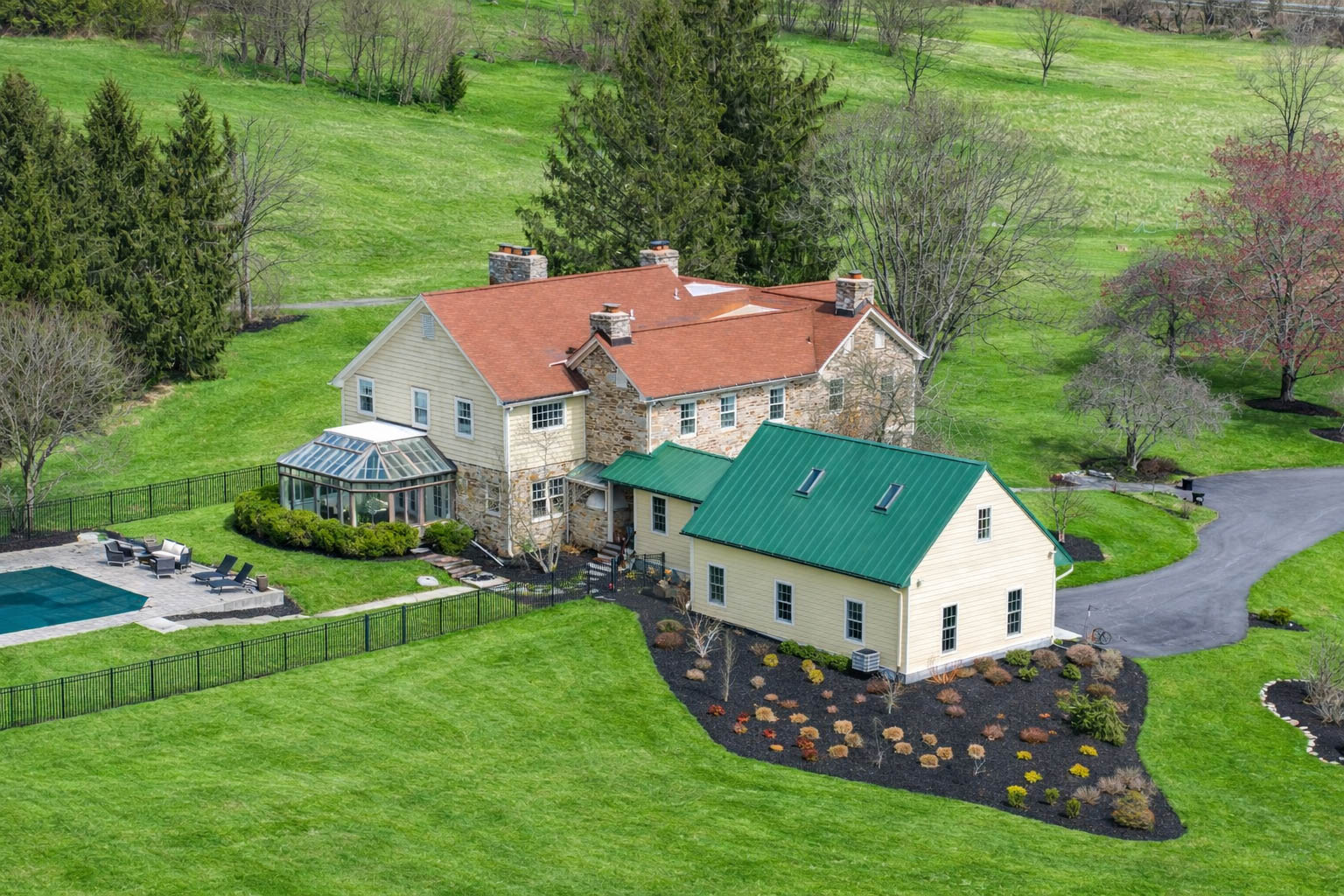 15314 PRICEVILLE ROAD, SPARKS GLENCOE, MD 21152 – Aerial view of stone manor house and white green-roofed cottage nestled into rolling hillside lawns