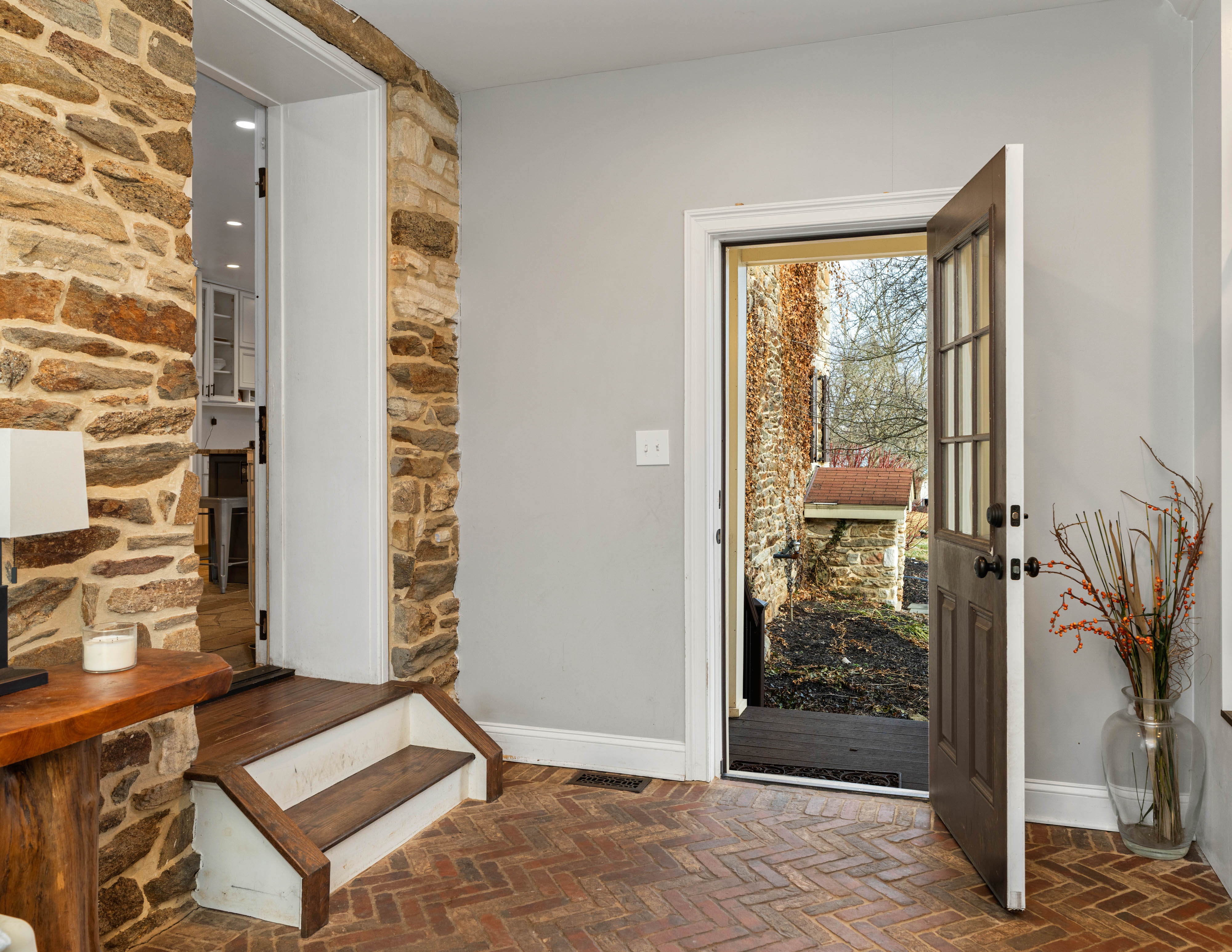 15314 PRICEVILLE ROAD, SPARKS GLENCOE, MD 21152 – Hallway with exposed stone wall, hardwood floors, and an open doorway leading outdoors