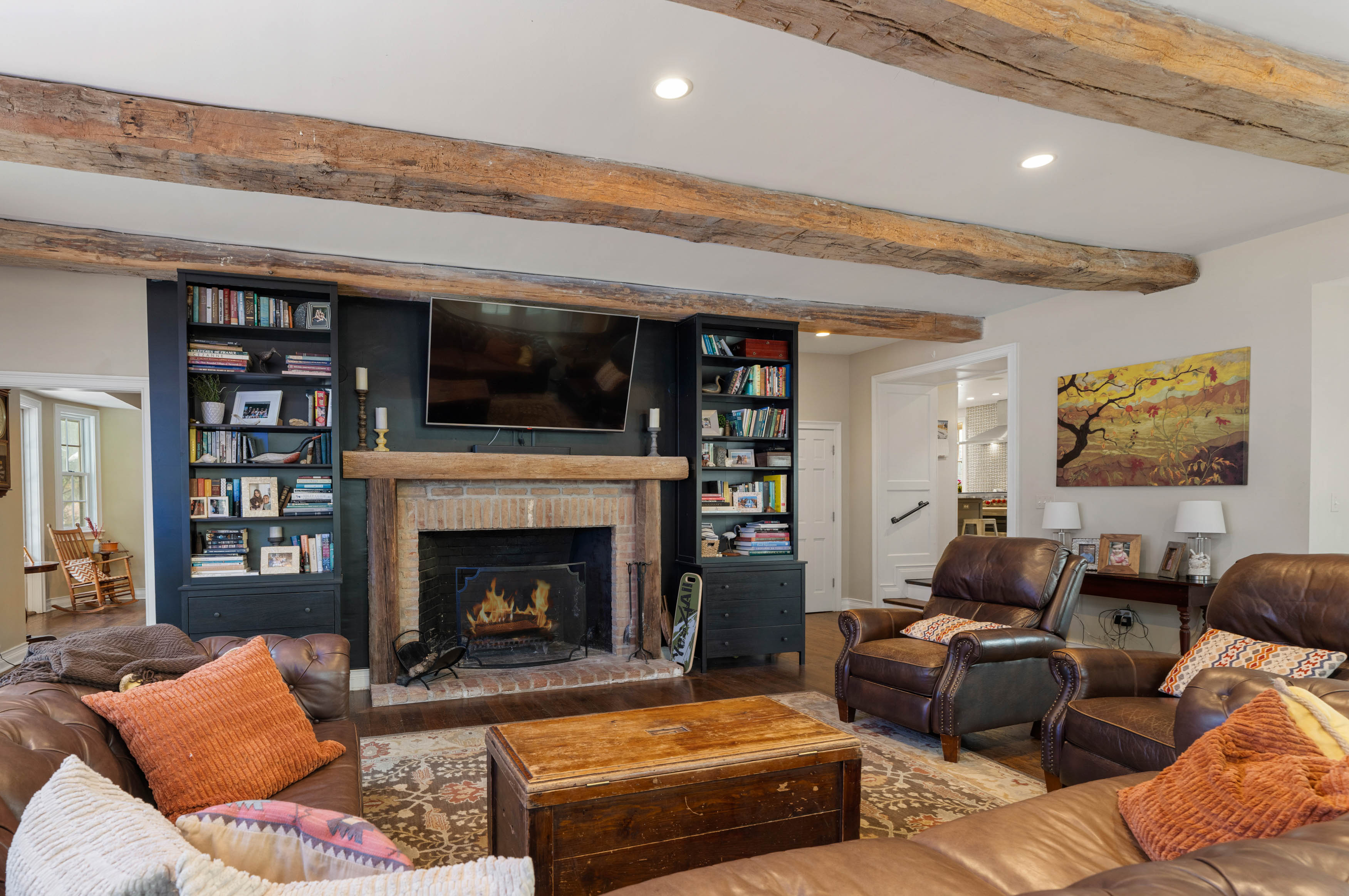 15314 PRICEVILLE ROAD, SPARKS GLENCOE, MD 21152 – Great room with exposed beams, fireplace wall with built-in shelving, and comfortable leather seating