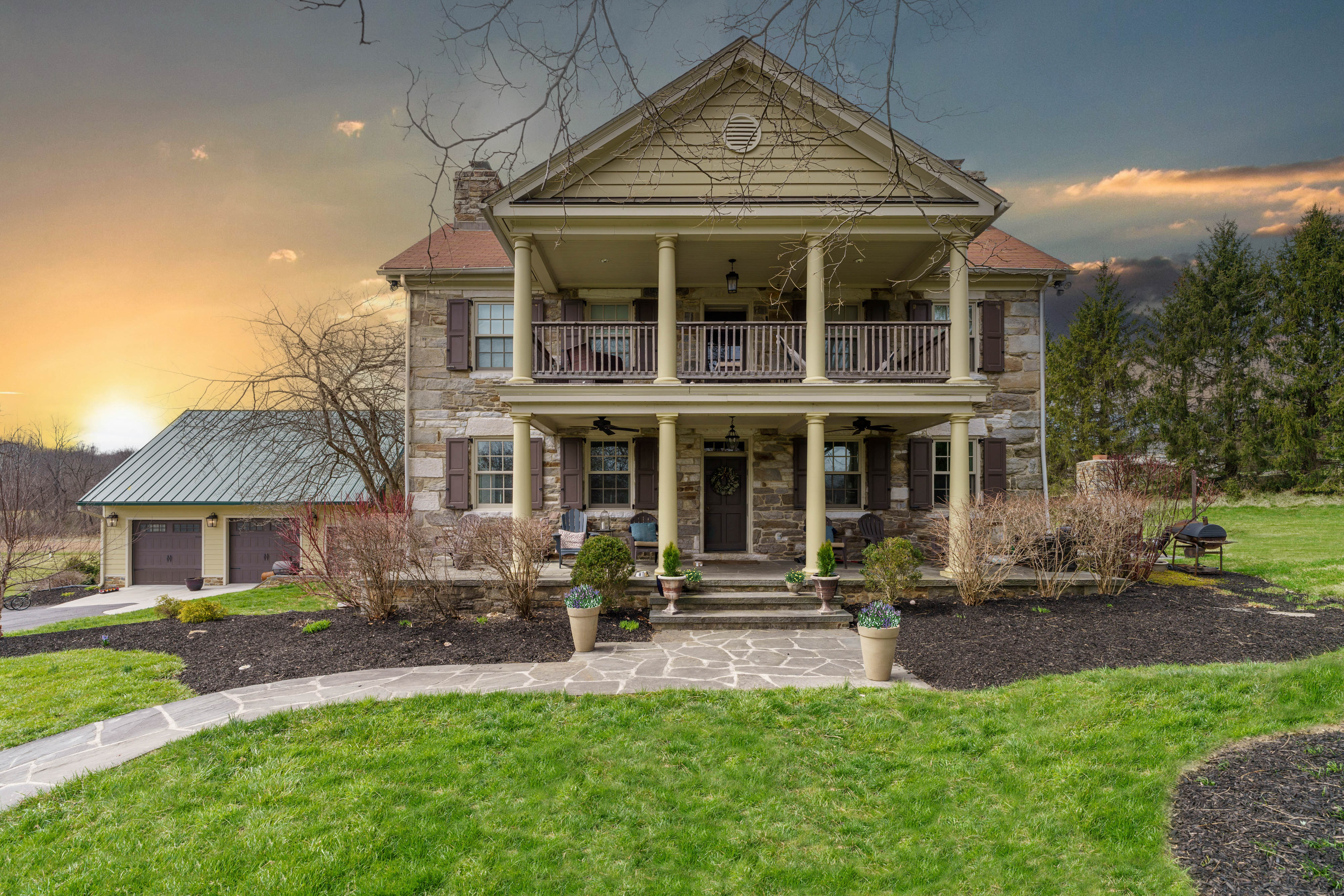 15314 PRICEVILLE ROAD, SPARKS GLENCOE, MD 21152 – Stone manor house with columned two-story porches and landscaped front lawn at sunset
