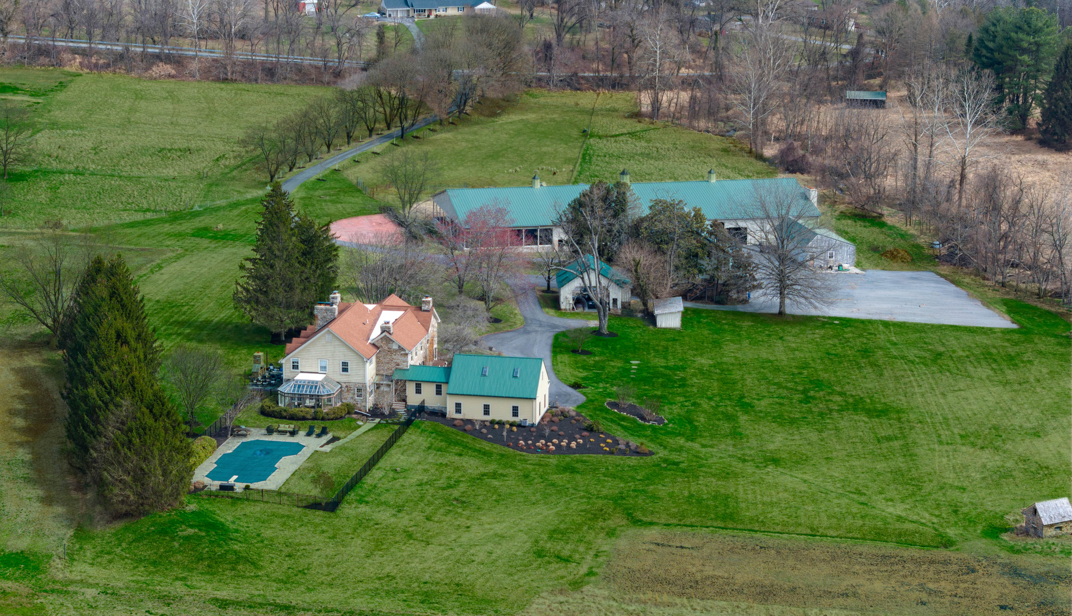 15314 PRICEVILLE ROAD, SPARKS GLENCOE, MD 21152 – Aerial view of stone manor, pool, and outbuildings set among rolling green pastures